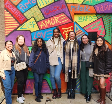 students in front of a mural